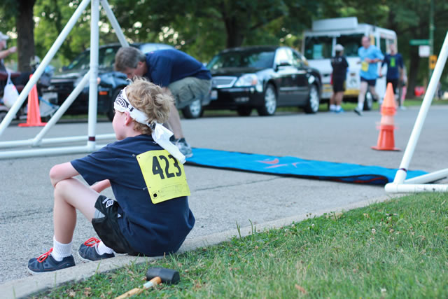 2nd finisher in the 1-Mile Lunar Orbit, Sean Grill watches the action at the finish line